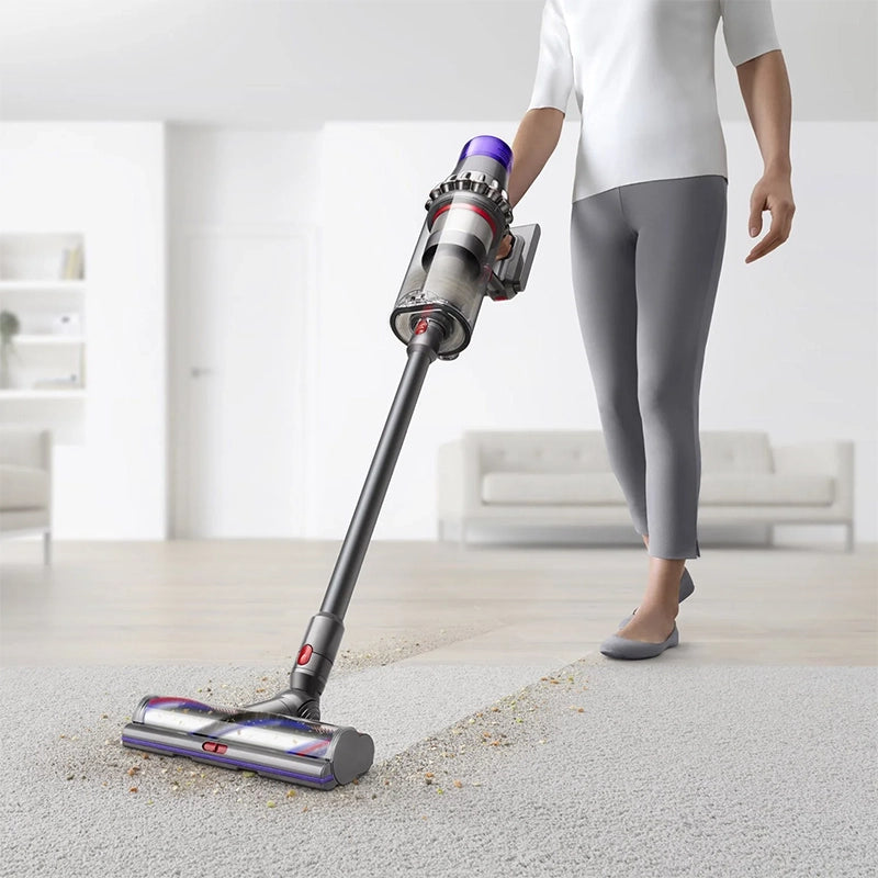 Dyson Outsize Extra cordless stick vacuum cleaner in use on carpet floor
