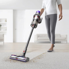 Dyson Outsize Extra cordless stick vacuum cleaner in use on carpet floor