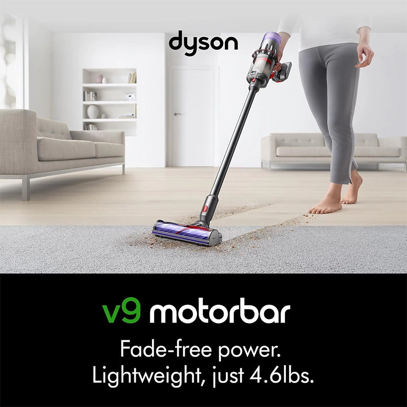 Dyson V9 Motorbar cordless stick vacuum cleaner used on carpet in living room