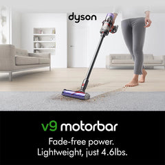 Dyson V9 Motorbar cordless stick vacuum cleaner used on carpet in living room